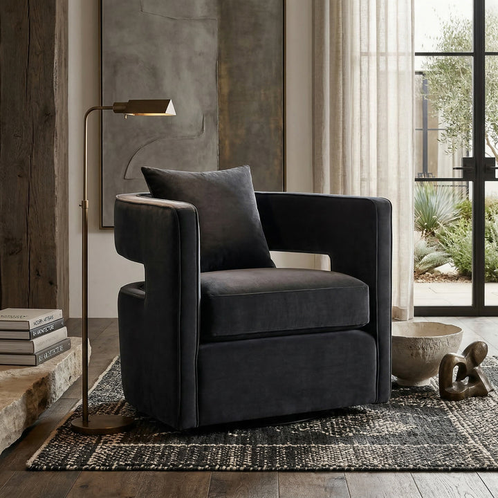 Black Rhonda swivel chair for living rooms, featuring a modern design with a rounded seat and sleek base.