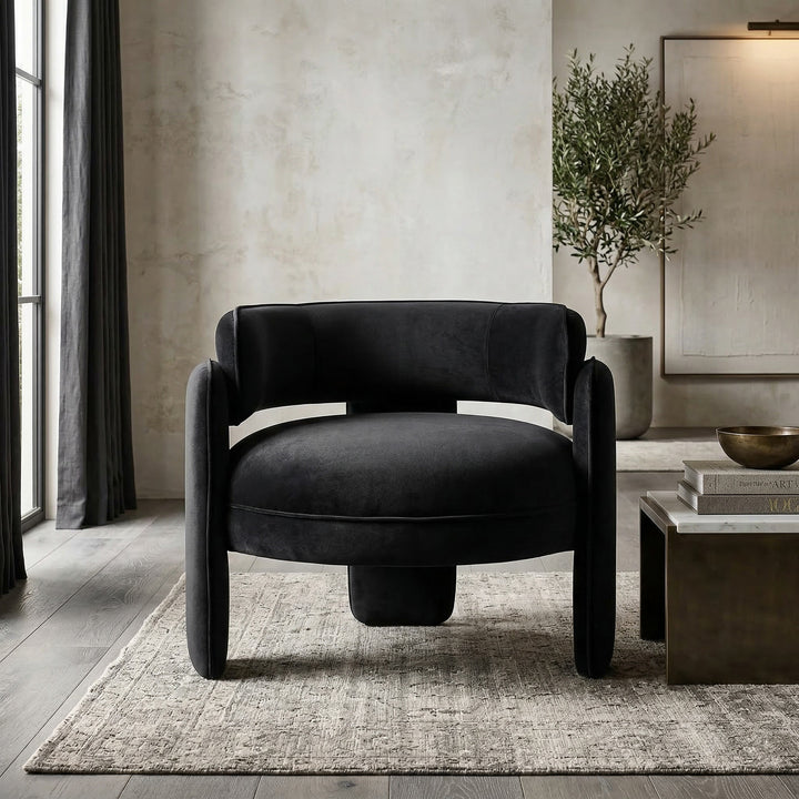 Black Chilli Chair, modern occasional chair with sleek design, featuring a rounded seat and stylish black upholstery in a contemporary living room.