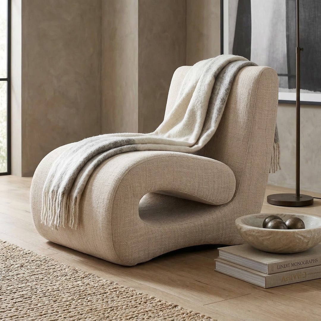Nano banana Alfieri occasional chair in a living room setting with neutral upholstery and wooden legs.