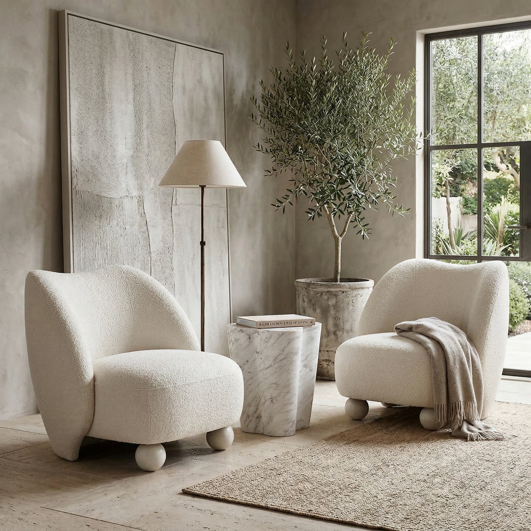 Living room with a modern Ballas Chair, a stylish casual occasional chair with a rounded design and soft fabric upholstery.