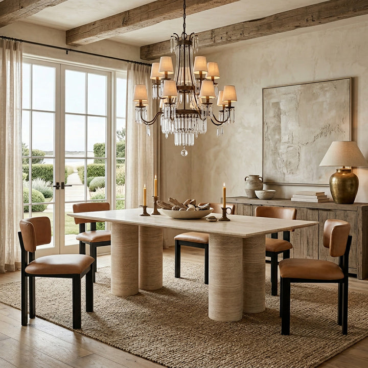 Tan leather Modenese dining chair with sleek design, shown beside a rectangular travertine dining table.