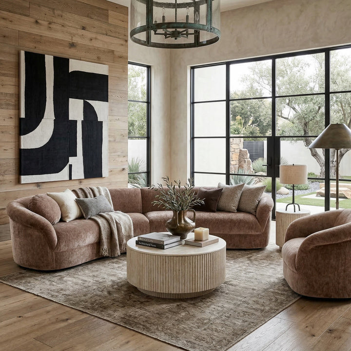 Curved Chiara sofa in matching fabric, modern design, with plush cushions, placed in a contemporary living room setting.