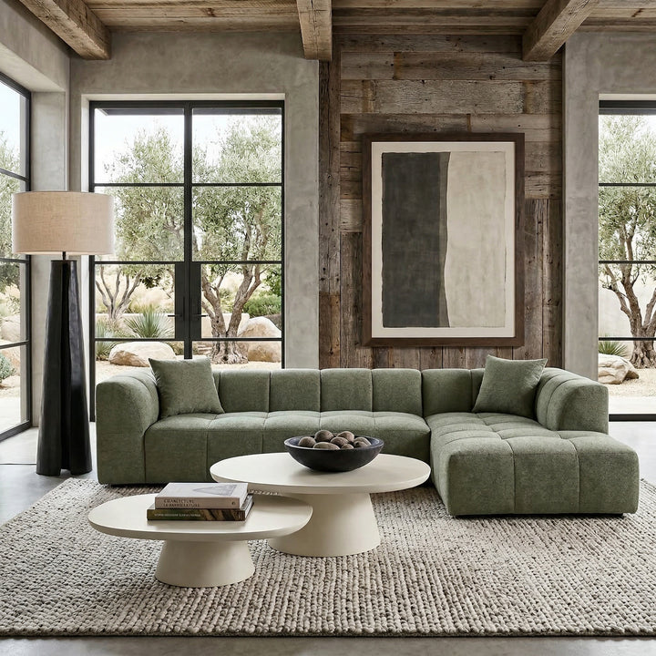 Moss green Sorenti corner sofa with plush fabric and modern design, shown in a spacious living room setting.
