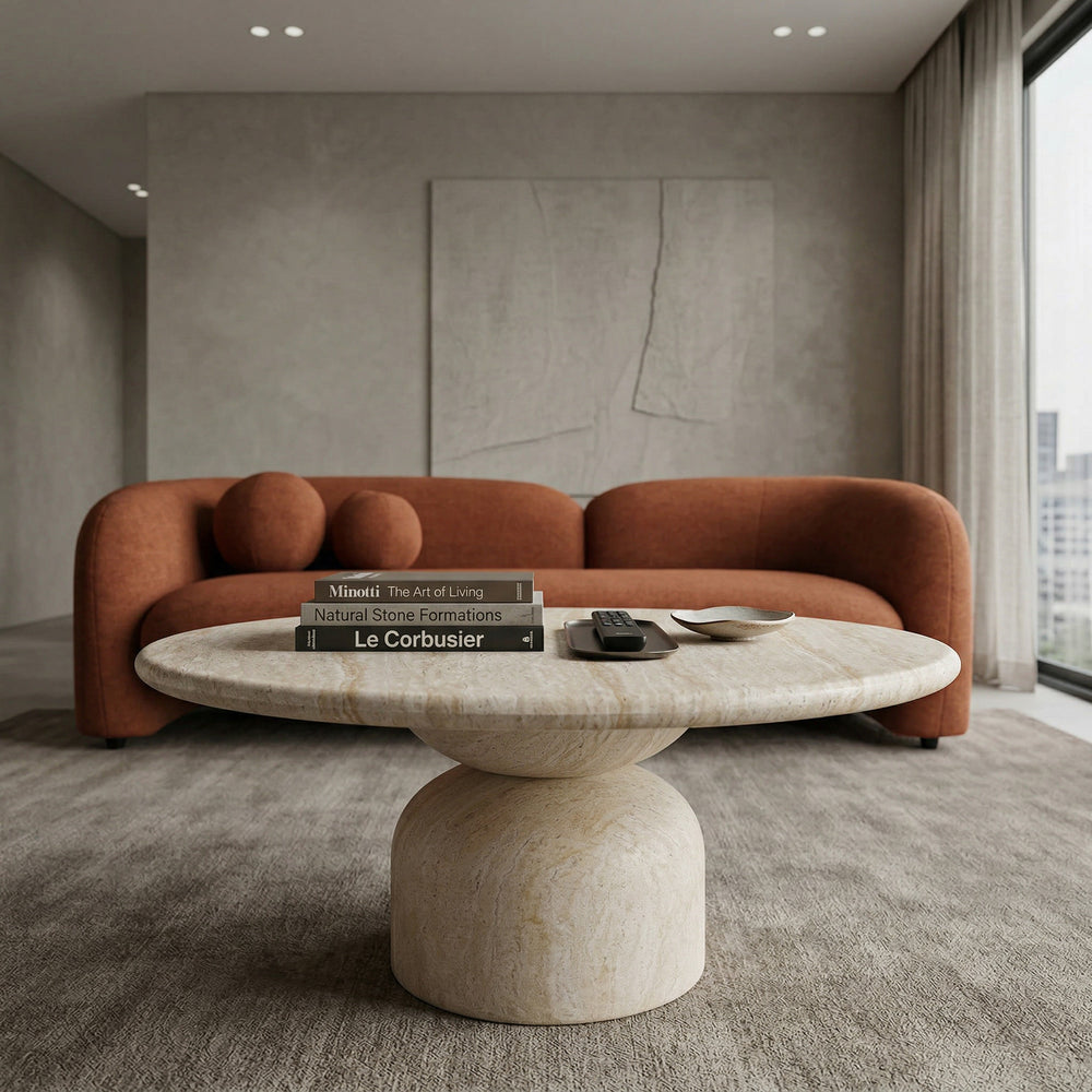 Modern Synthia coffee table with a travertine surface, paired with a sofa for a stylish living room setup.