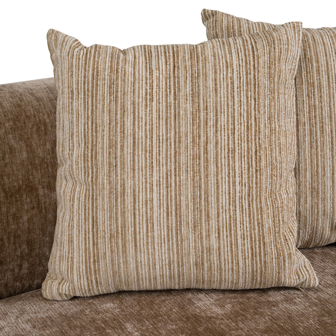 Curved Chiara sofa with plush fabric and modern design, featuring comfortable seating and sleek curves in a contemporary living room setting.